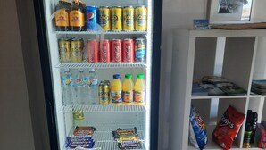 A vending machine stocked with beverages and snacks, including cans, bottles, and boxed items. - Econo Lodge Chaparral Motel Ballina (West Ballina)