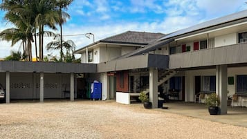 Stroll through the covered walkway and enjoy the tranquil courtyard with potted plants and palm trees.