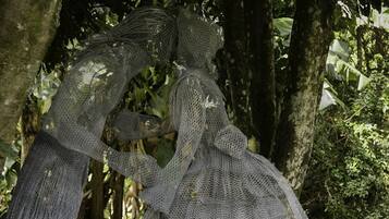 A sculpture of a woman in a forest setting.