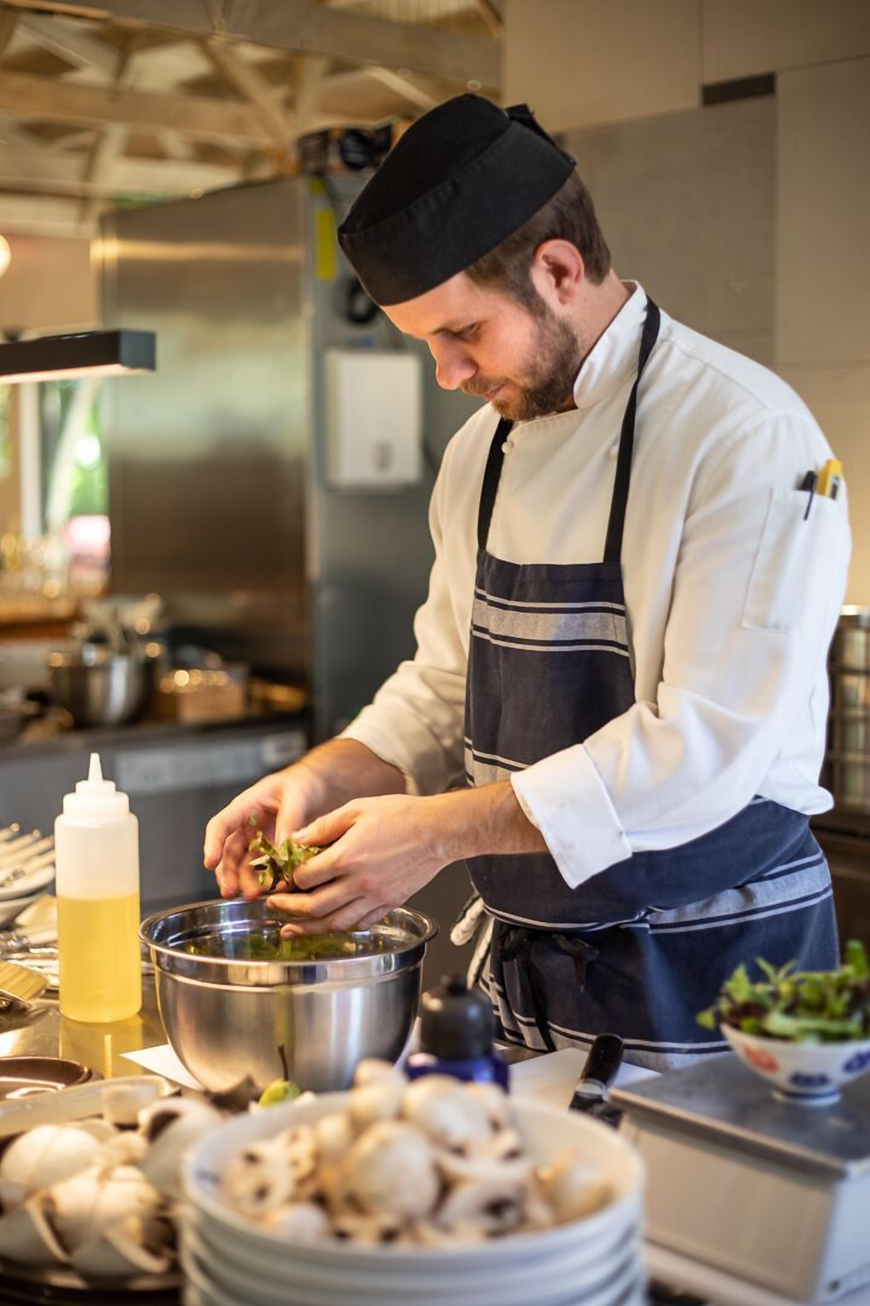 A chef preparing food in a kitchen.