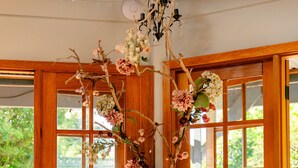 A wooden door with glass panels and a floral arrangement.