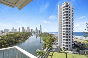 A high-rise hotel with a river view, a tennis court, and a beachside location.