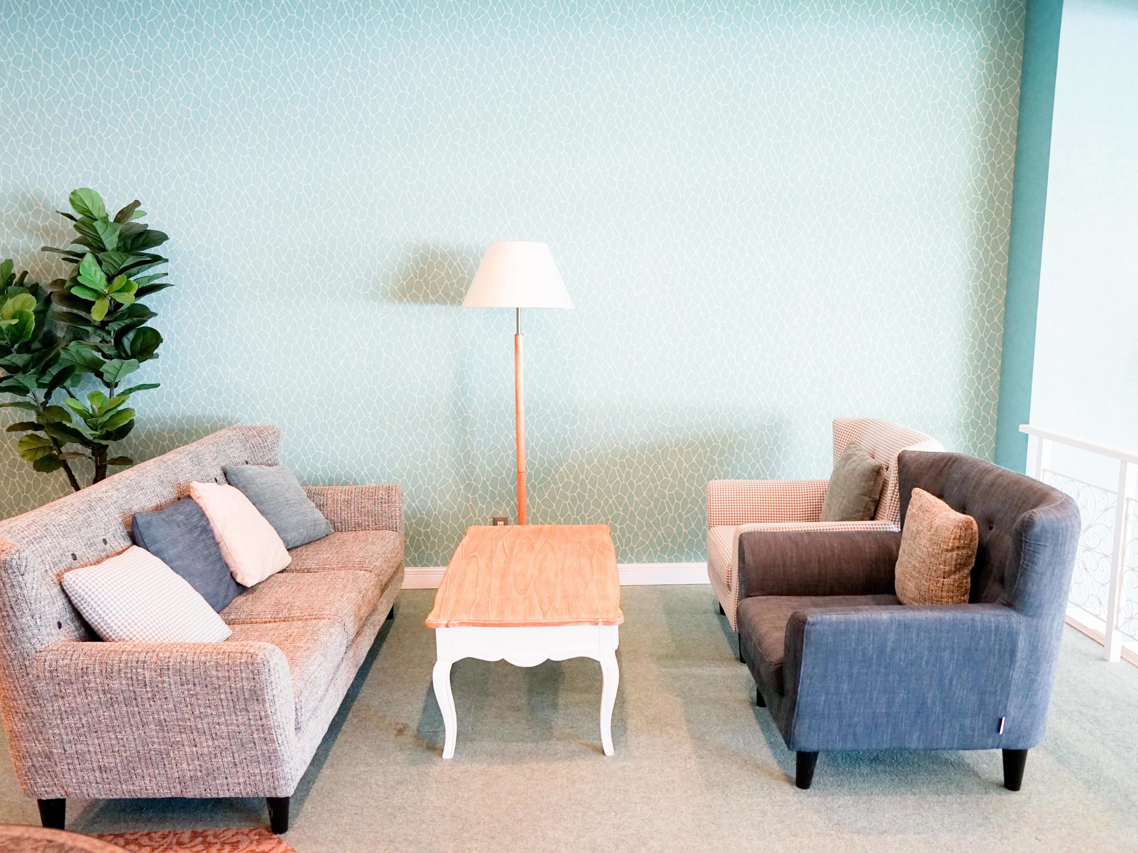 A living room with two sofas, a coffee table, and a floor lamp.