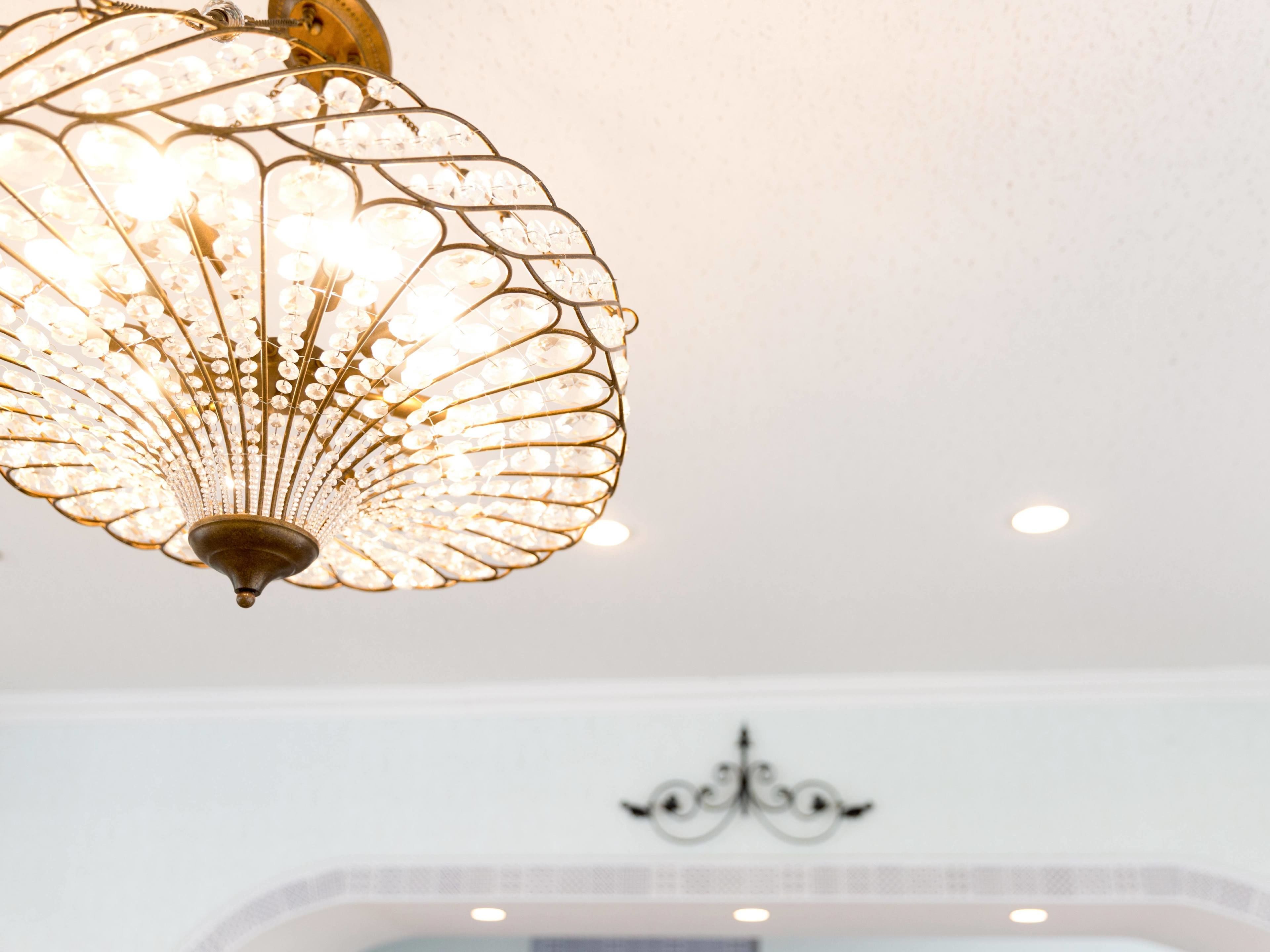 A chandelier with a fan-like design and multiple light bulbs.
