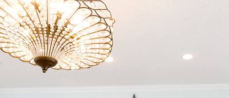 A chandelier with a fan-like design and multiple light bulbs.
