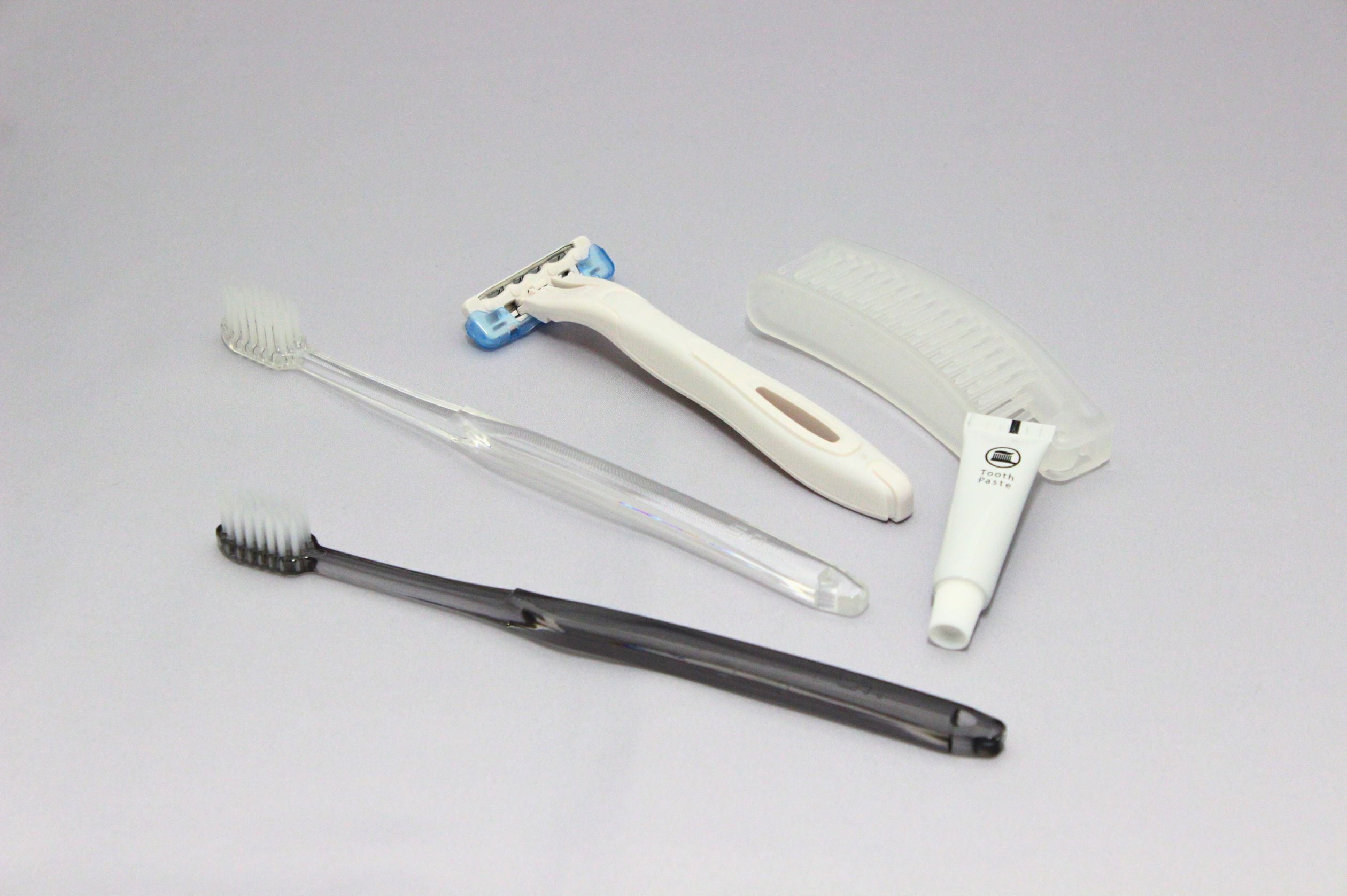 Four dental hygiene tools: a toothbrush, a dental floss, a dental scaler, and a dental mirror.