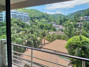 A view from a balcony overlooking a residential area with houses and lush greenery. - Mellow Space Boutique Rooms (Karon)