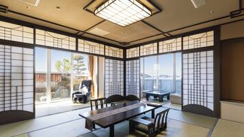 A traditional Japanese room with tatami flooring, a low table, and sliding doors.