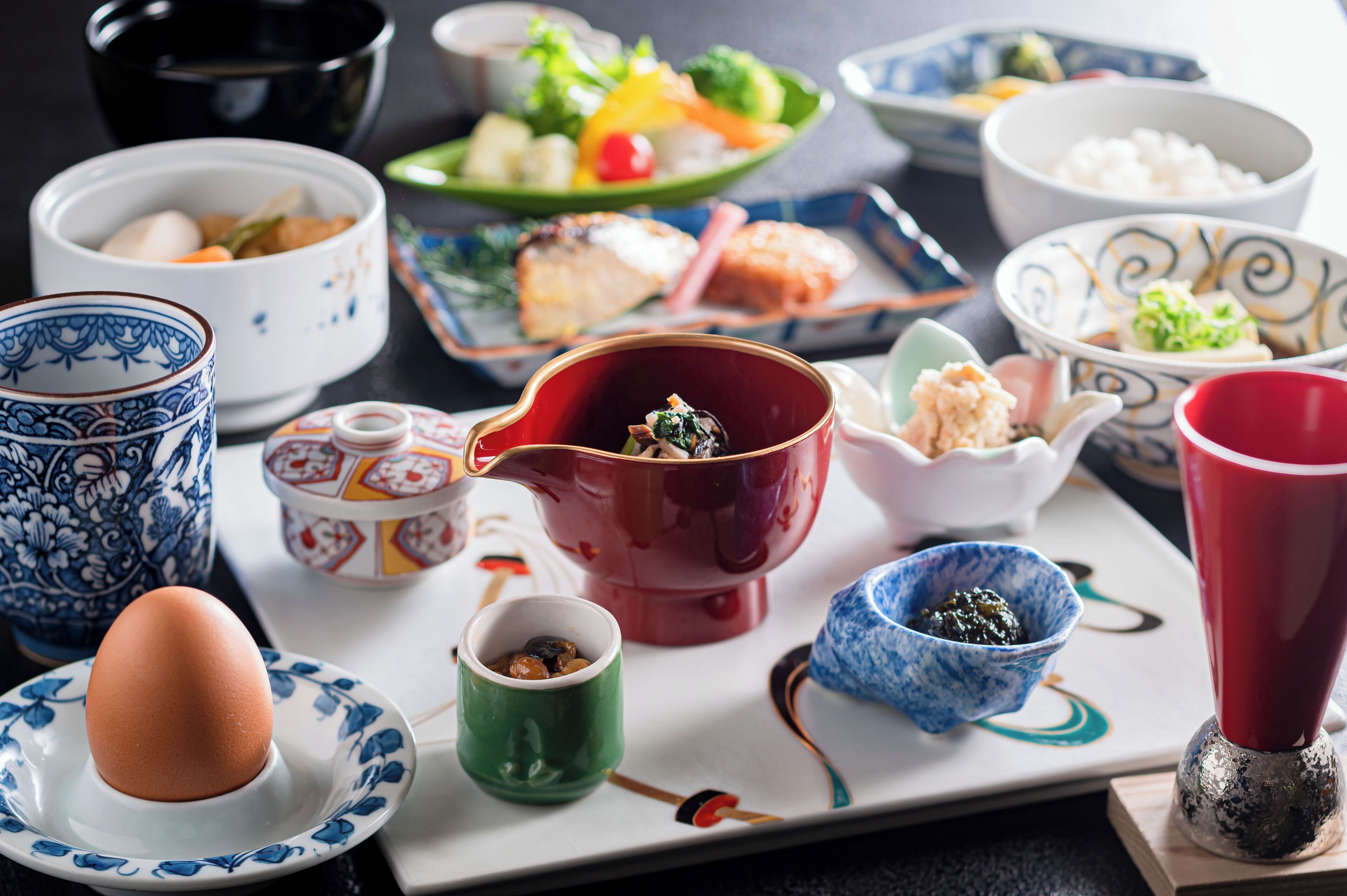 A variety of traditional Japanese dishes and bowls on a table.
