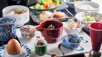 A variety of traditional Japanese dishes and bowls on a table.