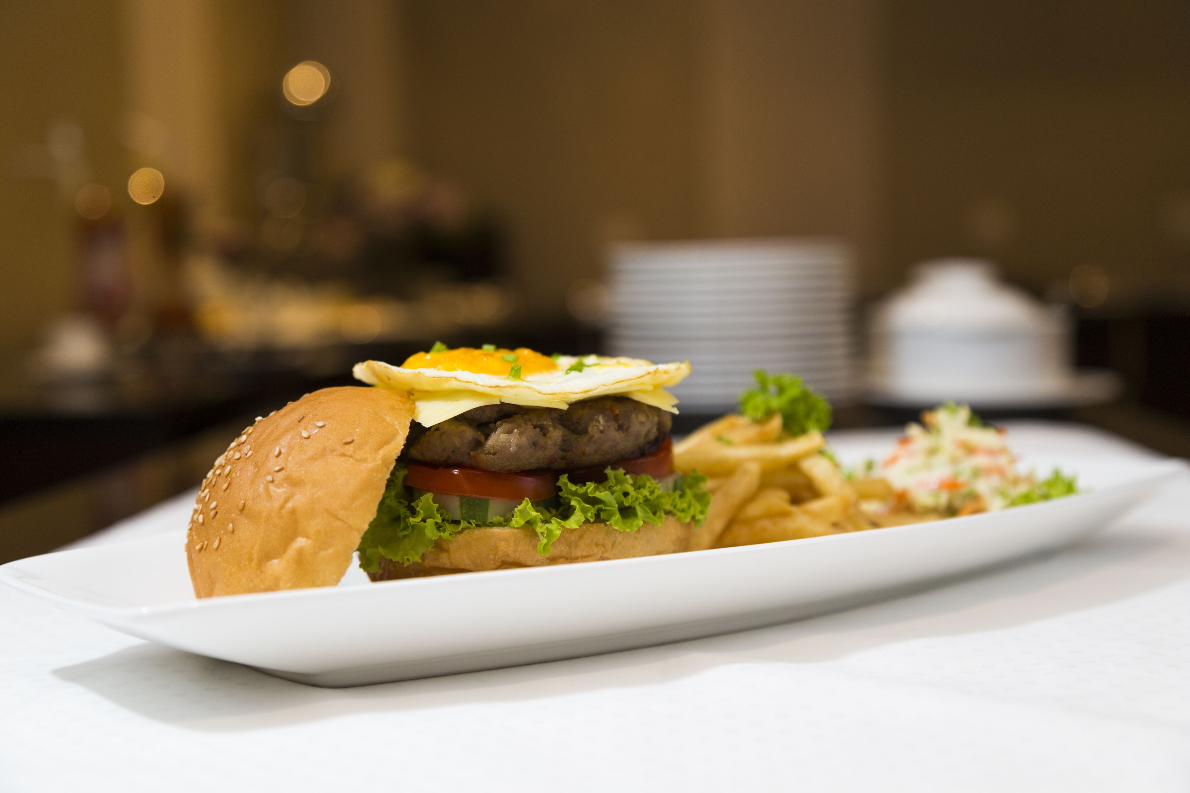 A plate with a hamburger, fries, and a salad.