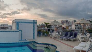 Alberca al aire libre y camastros