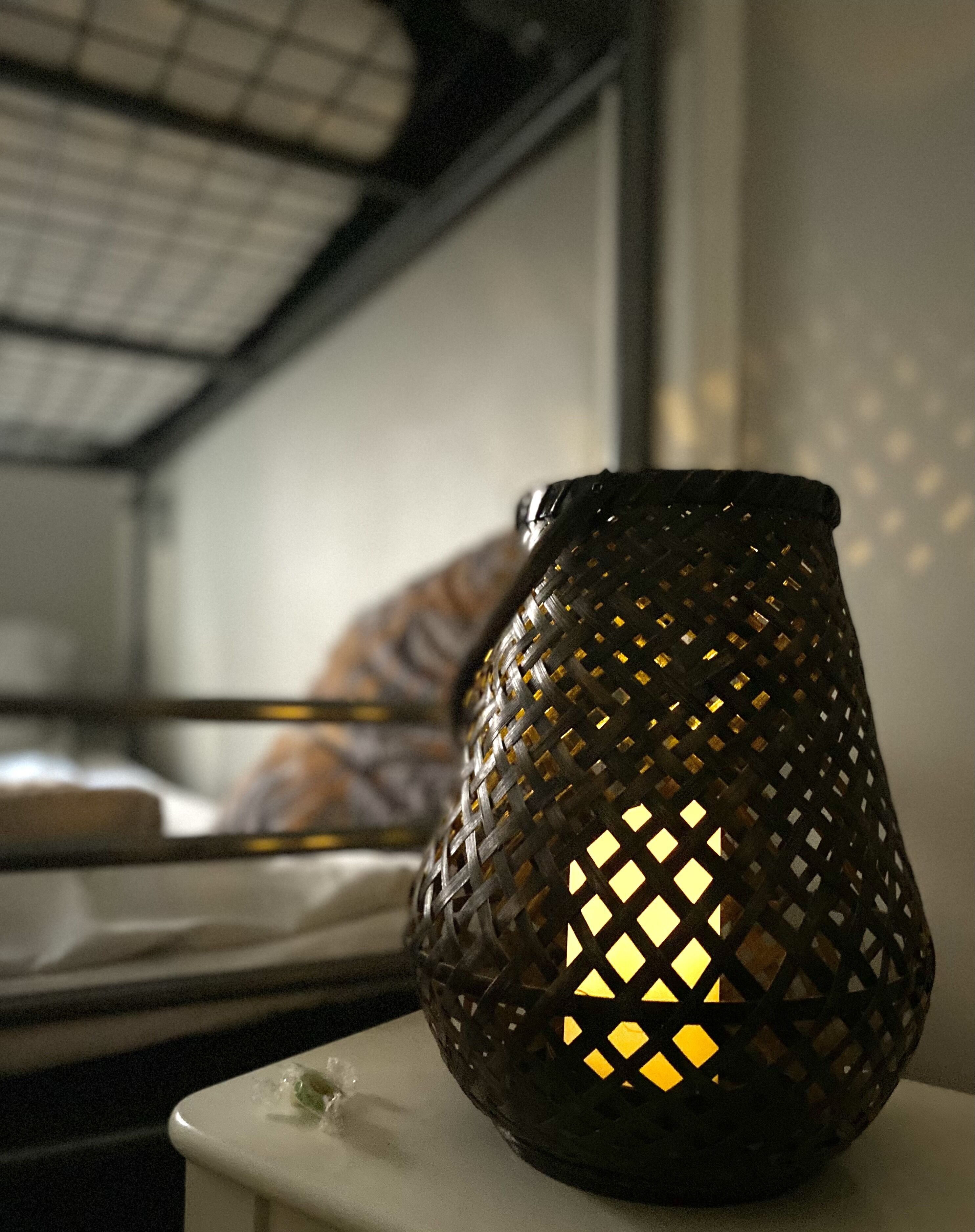 A candle holder with a geometric pattern on a white surface.