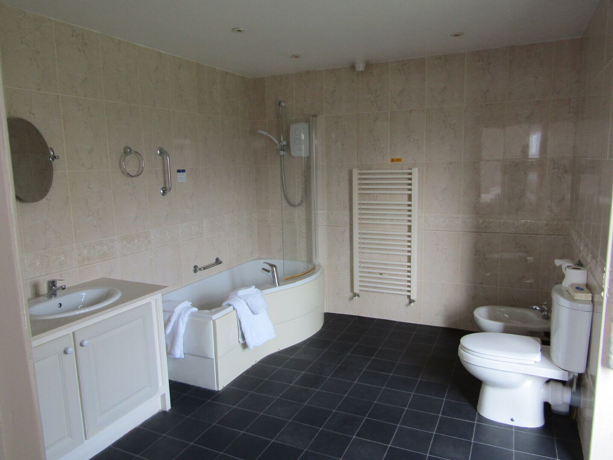 A bathroom with a bathtub, a toilet, and a sink.