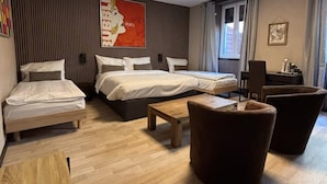 A hotel room with two single beds, a sofa, a small table, and a chair. - Hotel Parc & Lac (Montreux)