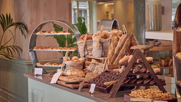 A bakery display with various breads and pastries. - The Level at the Melia White House (London)