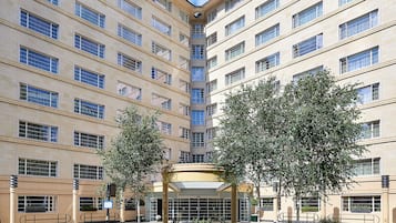 A multi-story hotel with a symmetrical facade, large windows, and a central entrance.
