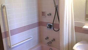 A bathroom with a walk-in shower, a bathtub, and a sink.