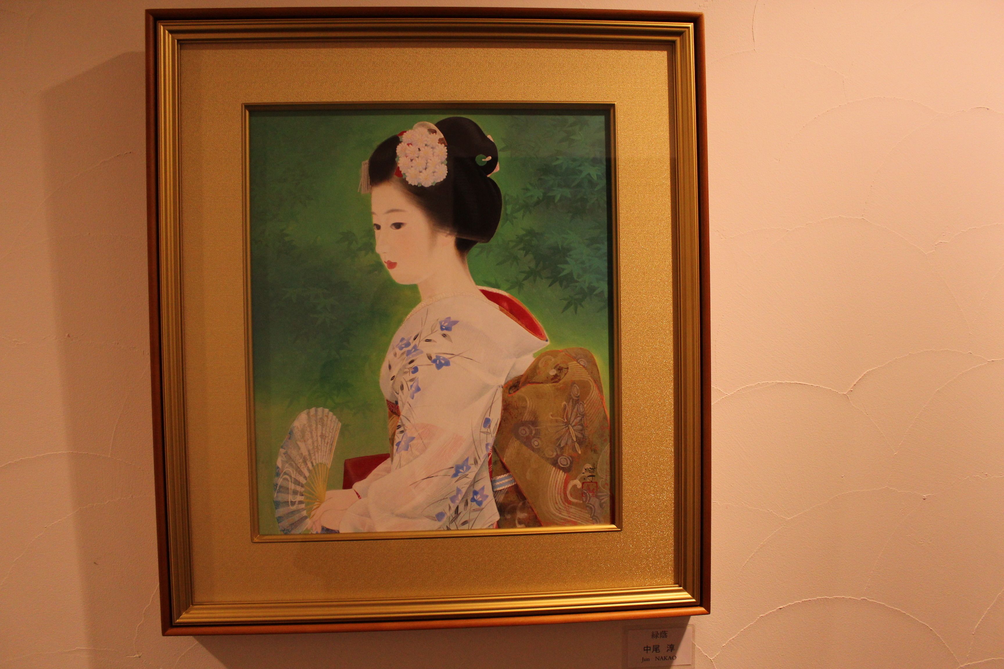 A framed artwork of a woman in traditional attire.