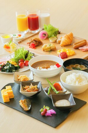 A variety of dishes including soup, rice, and vegetables, arranged on a wooden table. - Wishton Hotel Yukari (Sakura)