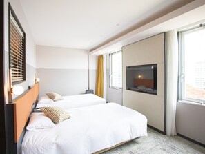 A hotel room with two beds, a large window, and a television on the wall. - Wishton Hotel Yukari (Sakura)