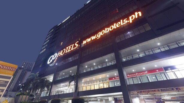 A hotel with a prominent sign reading "Gohotels" and a service center indicated by a red sign. - Go Hotels Plus Mandaluyong (Mandaluyong)