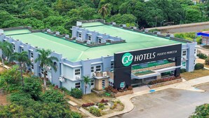 A hotel with a green roof, multiple buildings, and a sign reading "Go Hotels Puerto Princesa". - Go Hotels Puerto Princesa (Puerto Princesa)