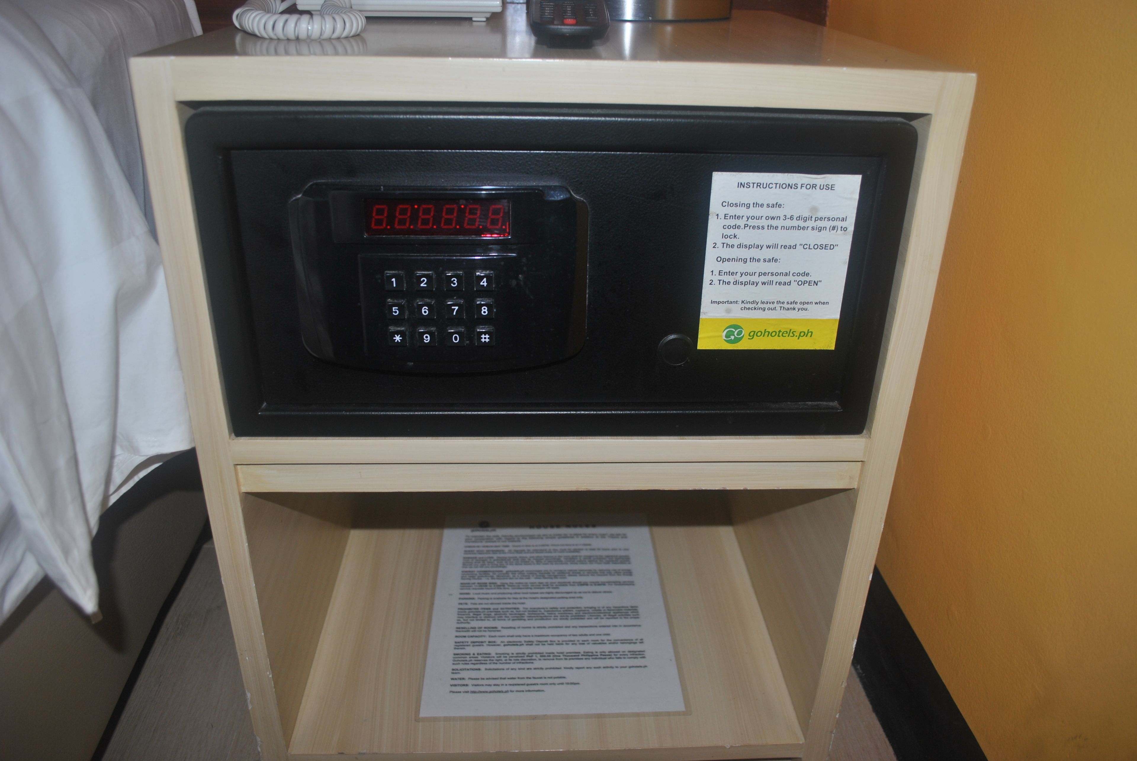 Caja fuerte de hotel con teclado digital e instrucciones de uso.