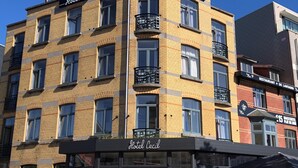 A multi-story hotel with a prominent 'Hotel Cecil' sign at the ground level. - Hotel Cecil (De Panne)