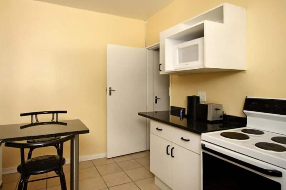 full-sized fridge, microwave, stovetop, cookware/dishes/utensils