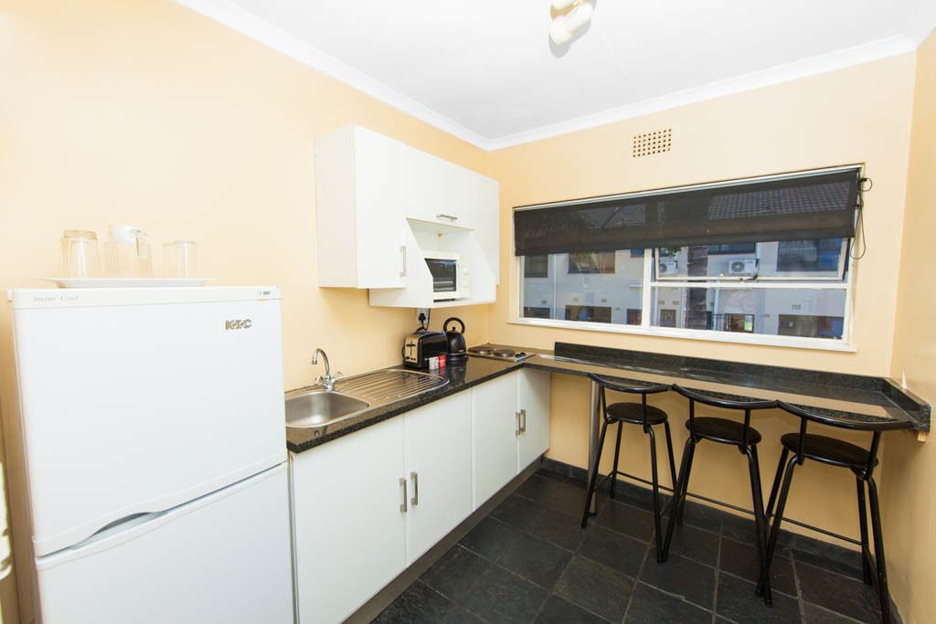 full-sized fridge, microwave, stovetop, cookware/dishes/utensils