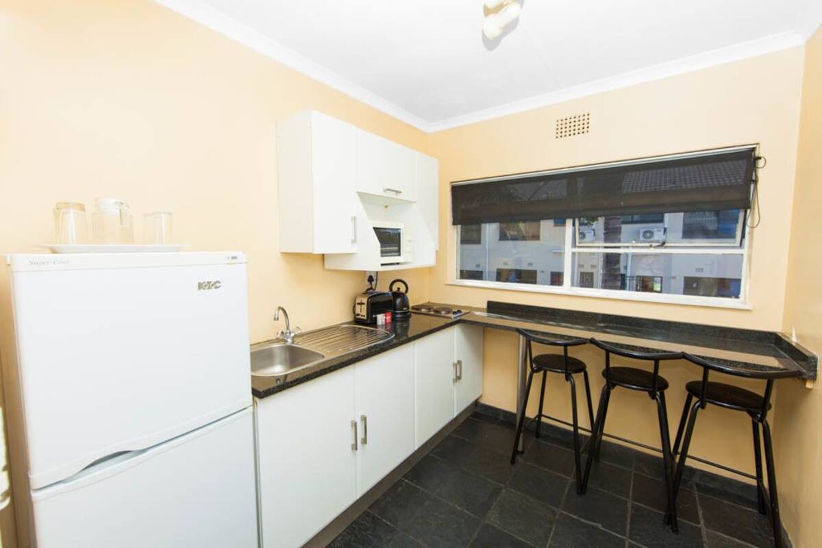 full-sized fridge, microwave, stovetop, cookware/dishes/utensils