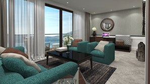 A modern living room with teal sofas, a coffee table, and a view of the sea. - Hotel Casa del Mare - Amfora (Orahovac)