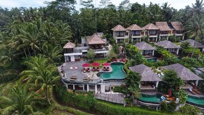 A resort with multiple bungalow-style buildings, a central pool area, and lush tropical vegetation. - Puri Sebali Resort (Ubud)