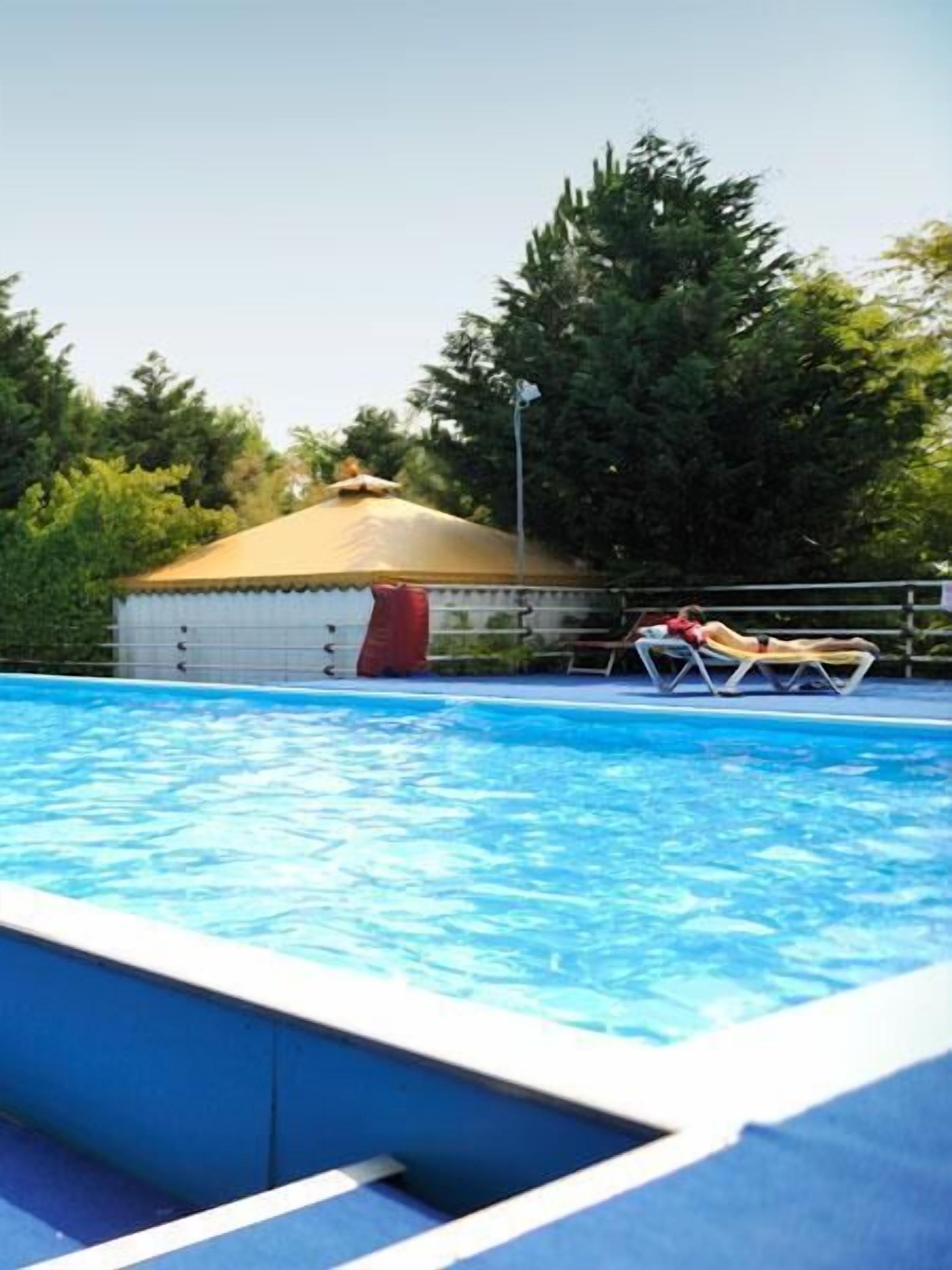 Seasonal outdoor pool, pool loungers