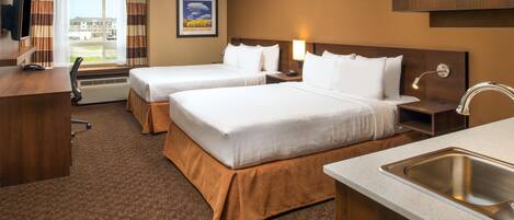 A hotel room with two beds, a desk, a TV, a window with curtains, a painting, and a sink.