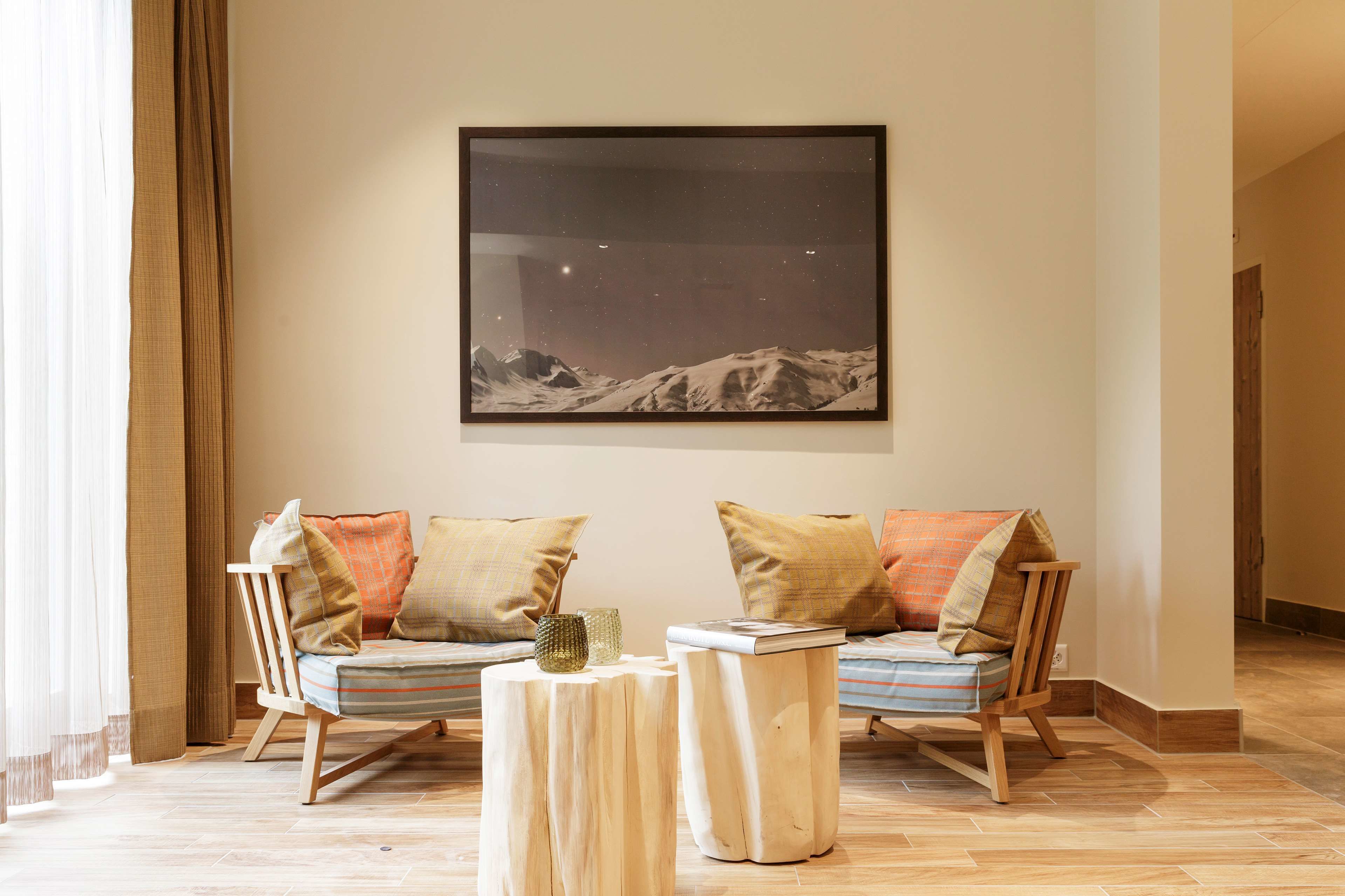A cozy living room with a sofa set, a coffee table, and a framed artwork on the wall.