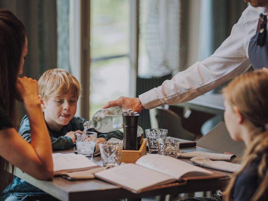 A table with a coffee maker, glasses, and books, suggesting a casual dining or meeting space.