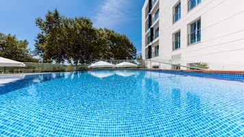 Seasonal outdoor pool, open 10:00 AM to 7:00 PM, pool umbrellas