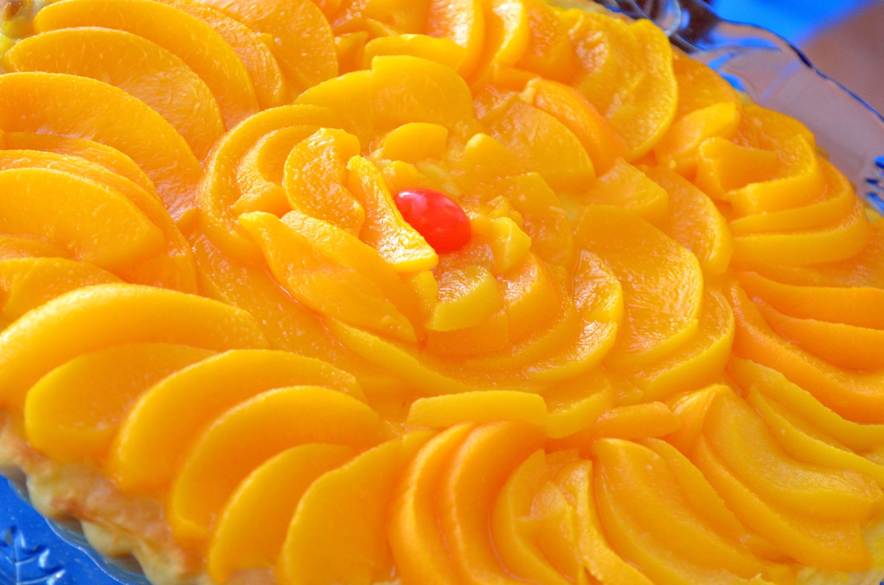 A dessert with sliced fruit arranged in a circular pattern.