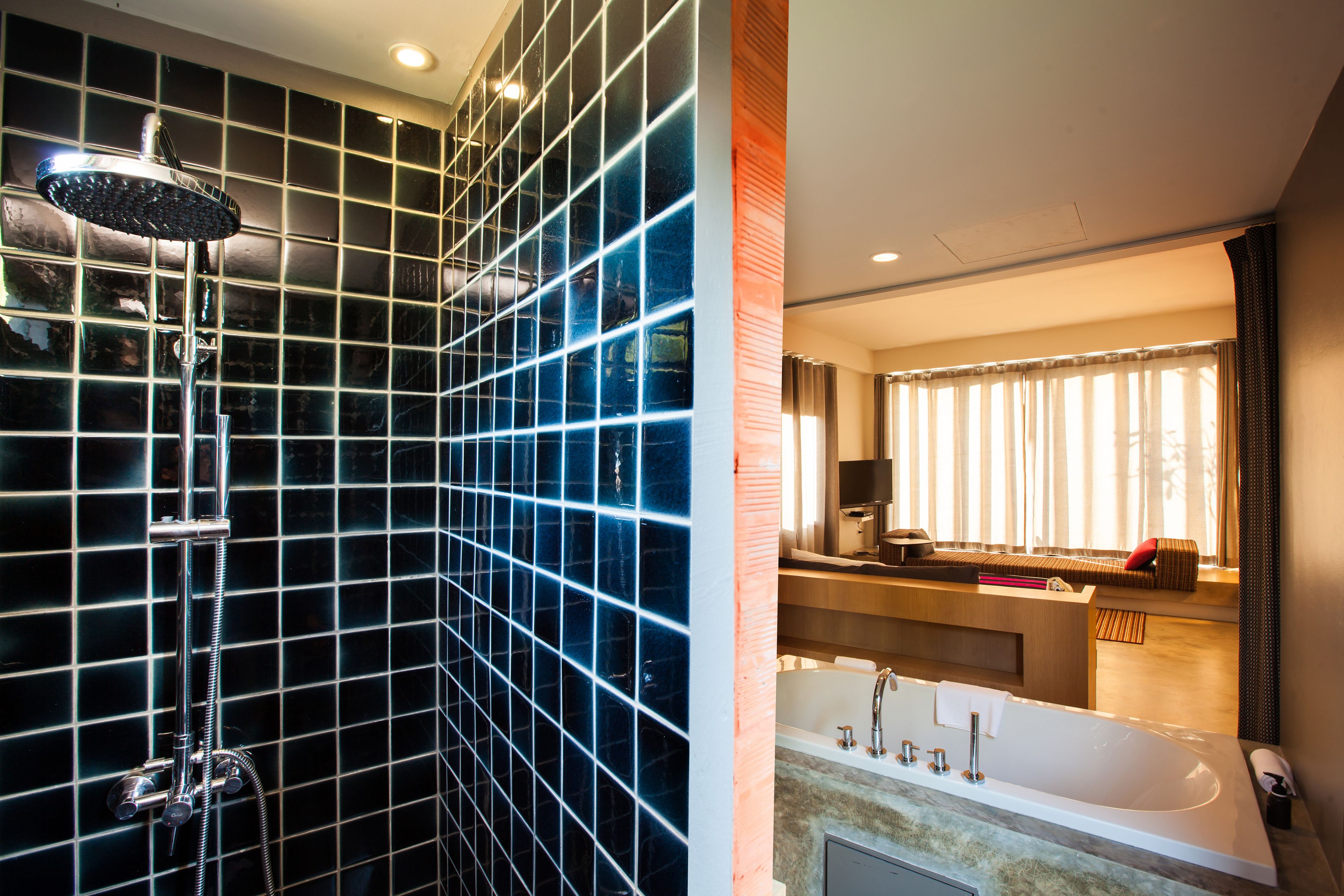 A modern bathroom with a large shower, a bathtub, and a vanity area.