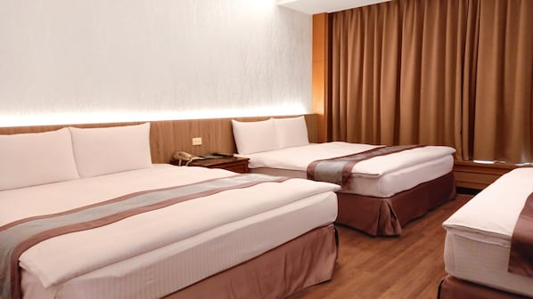 A hotel room with two beds, a bedside table with a phone, and a window with curtains. - Zhong Ke Hotel (Taichung)