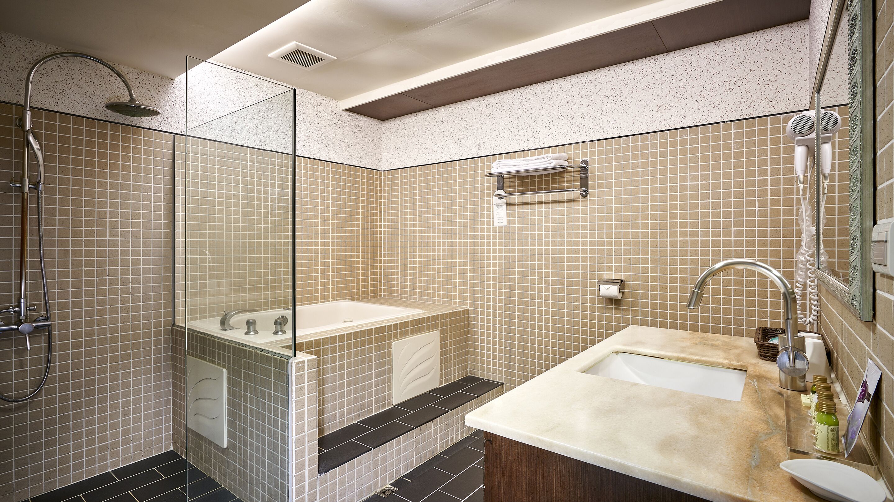 deluxe room | bathroom | hair dryer, towels, shampoo, toilet paper