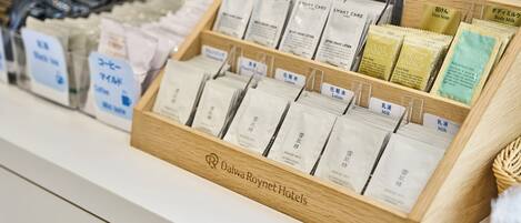 A display of toiletries including face soap, body milk, and lotion at a hotel.