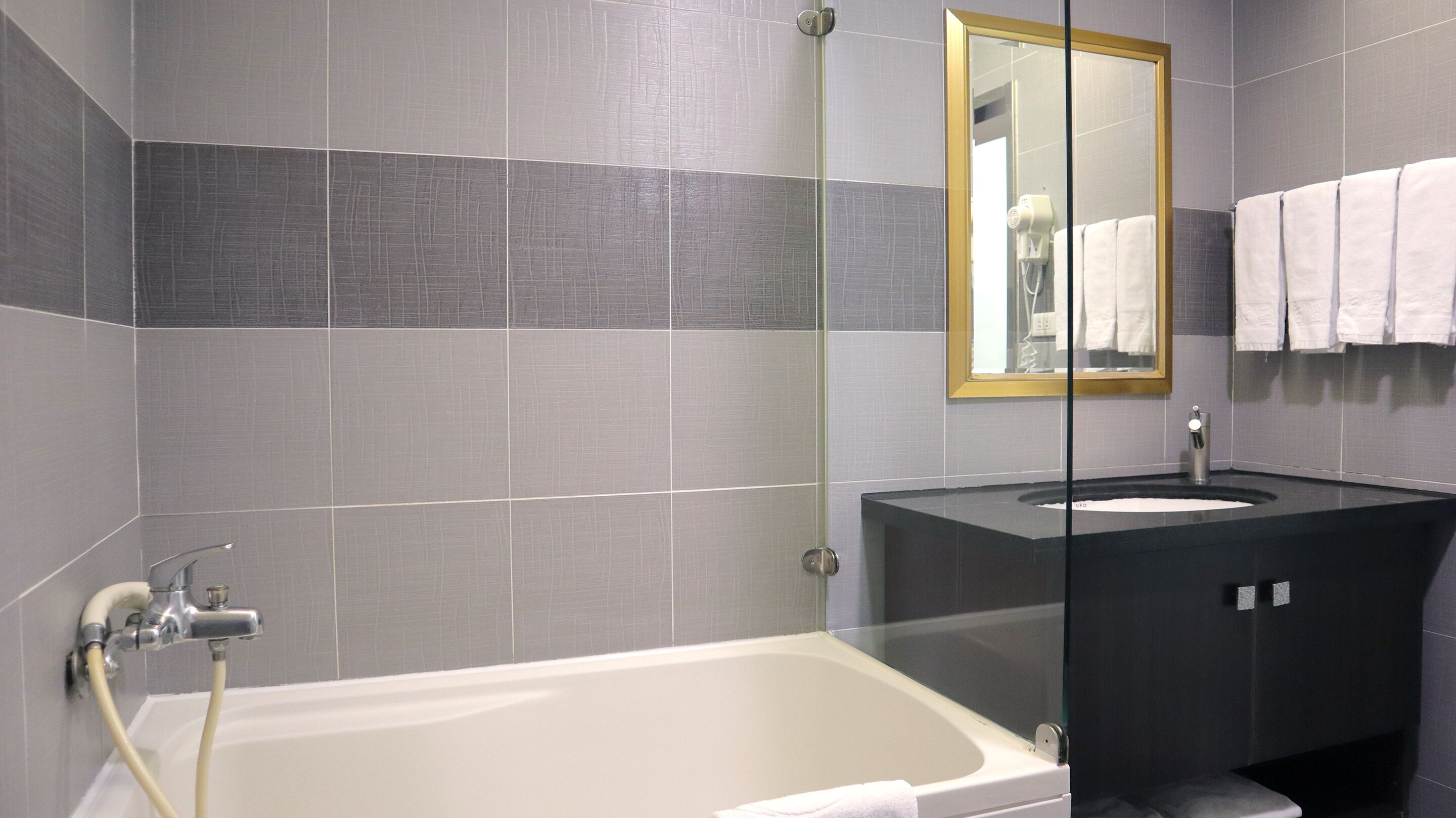 deluxe family room | bathroom | shower, hair dryer, towels