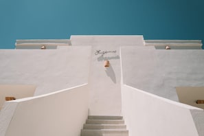 A staircase leading to a building entrance with a sign reading 'Bruges.'