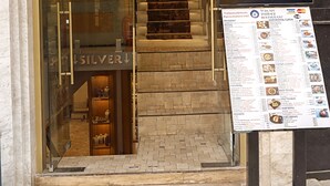 A hotel entrance with a staircase leading inside, a signboard with restaurant menu, and a visible jewelry store. - Turk Art Hotel (Istanbul)
