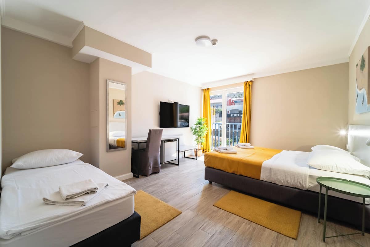 Standard Triple Room | Minibar, in-room safe, desk, laptop workspace