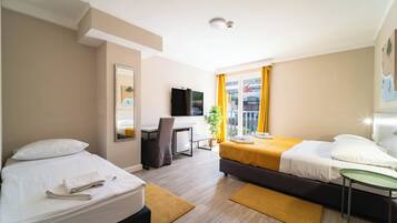 Standard Triple Room | Minibar, in-room safe, desk, laptop workspace