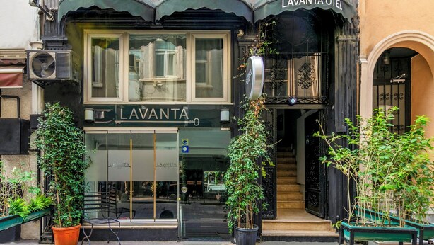 A building with a sign reading "LAVANTA HOTEL" and a black awning. There are potted plants in front of the entrance. - Lavanta Hotel (Istanbul)